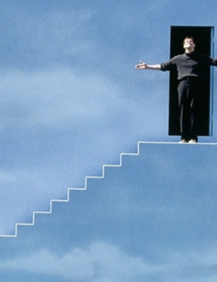 man coming out of doorway to stand on steps, with a background of clouds on the wall,and looking up at sky